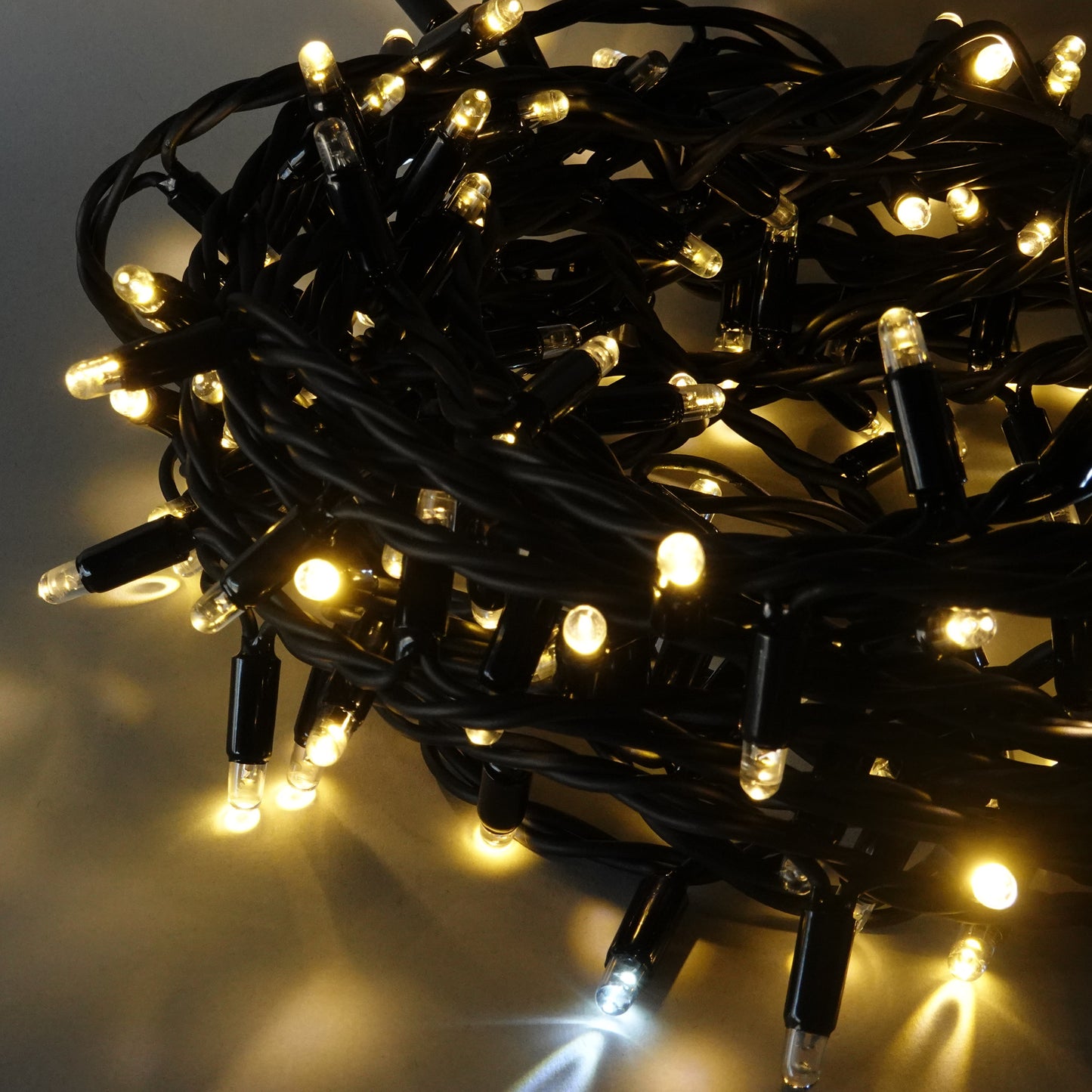 230V 8m micro light strings, warm white 3000K LEDs, with cold white 7000K flash, black cable